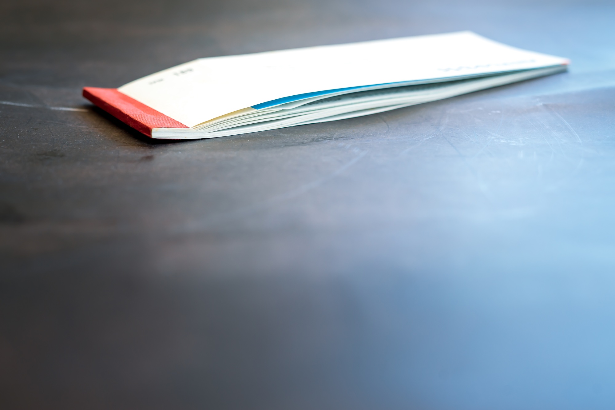 Closed cheque book on the table.