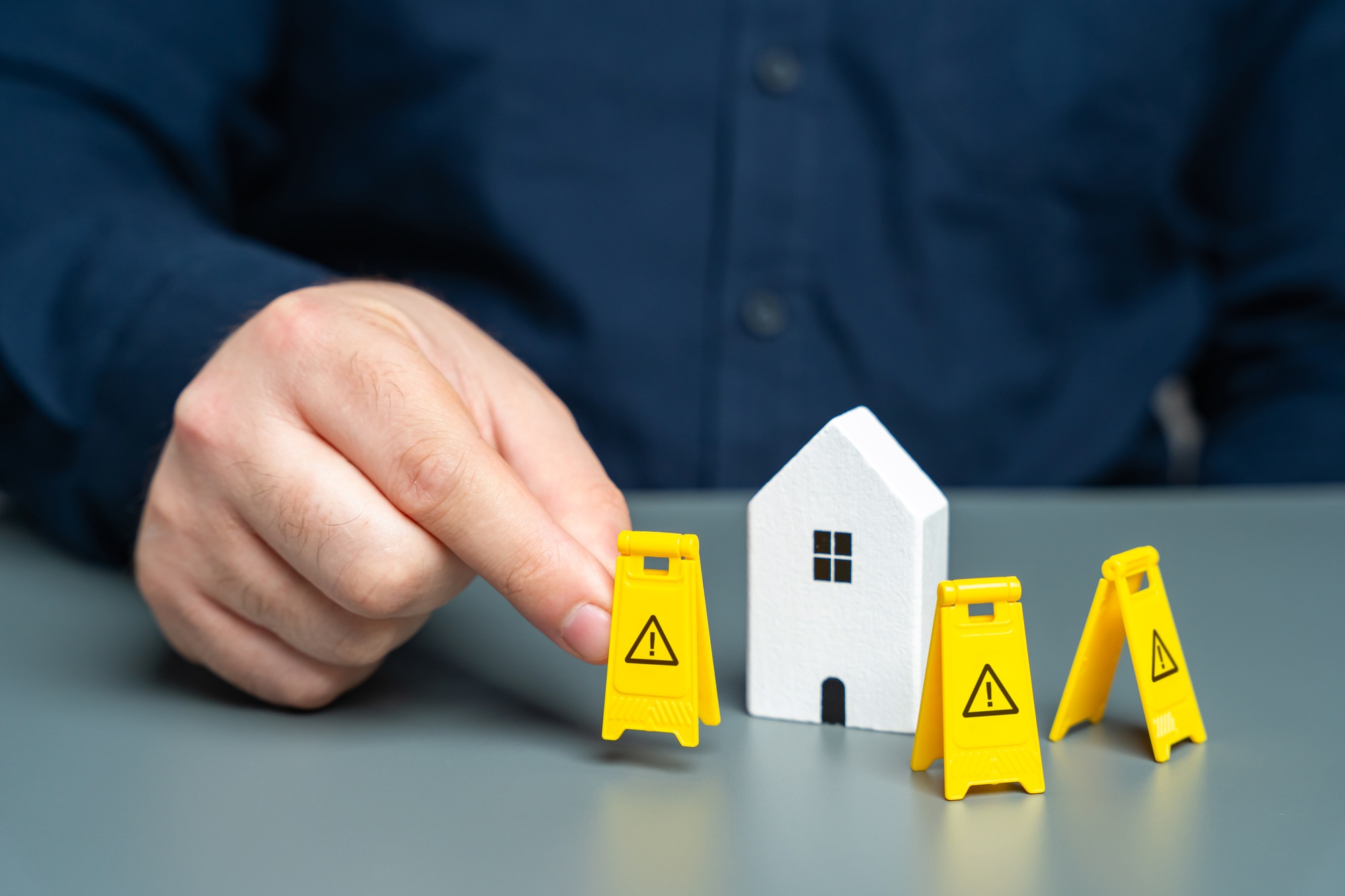 A man installs restriction signs around the house.